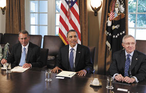 President Barack Obama, ,flanked by House Speaker John Boehner of Ohio, left, and Senate Majority Leader Harry Reid of Nev., meets with Republican and Democratic leaders regarding the debt ceiling on Monday in the Cabinet Room of the White House in Washington.