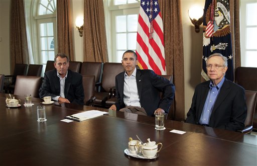 President Barack Obama meets with Senate Majority Leader Harry Reid of Nev., right, and House Speaker John Boehner of Ohio, left, in the Cabinet Room of the White House, Saturday, July 23, 2011, in Washington, to discuss the debt.