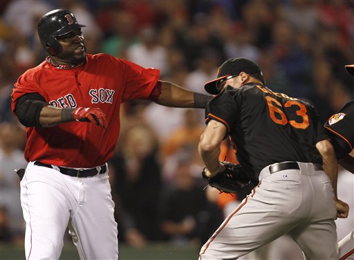 Boston Red Sox designated hitter David Ortiz takes a swing at Baltimore Orioles relief pitcher Kevin Gregg (63) after they exchanged words after Ortiz flied out during the eighth inning Friday at Fenway Park in Boston.