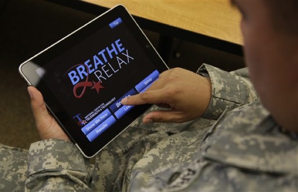 Sgt. Mark Miranda, a public affairs specialist stationed at Joint Base Lewis-McChord in Washington state, demonstrates the use of a program for tablet computers and smart phones that is designed to help calm symptoms of post-traumatic stress and traumatic brain injury, Friday, July 22, 2011. Miranda said he does not suffer from PTSD, but after trying the app, he said he may suggest its use to other soldiers who he has deployed with. (AP Photo/Ted S. Warren)