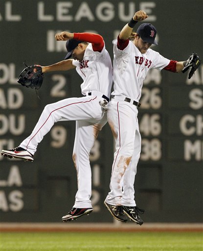 Boston Red Sox outfielders Jacoby Ellsbury, left, and Josh Reddick celebrate their 13-9 victory over the Kansas City Royals on Tuesday at Fenway Park in Boston.