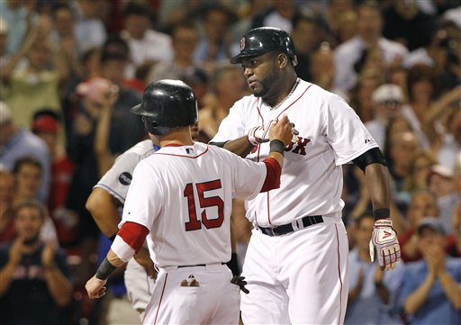 Boston Red Sox designated hitter David Ortiz is congratulated by Dustin Pedroia (15) after hitting a grand slam against the Kansas City Royals in the fourth inning Wednesday at Fenway Park in Boston.