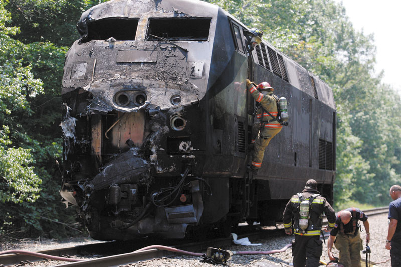 Firefighters work at the scene of an Amtrak passenger train that collided with a tractor-trailer Monday in North Berwick, leaving the driver of the tractor trailer dead and several passengers aboard the train injured.