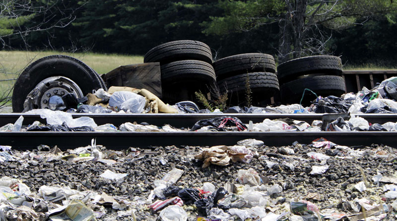 Wreckage of the trash-hauling tractor-trailer lies alongside the tracks at the site of the collision.