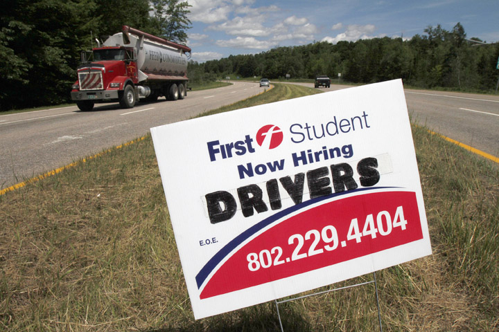 A sign looking to hire drivers, is placed on a roadway in Berlin, Vt., on Thursday. In June, employers added only 18,000 jobs nationwide.