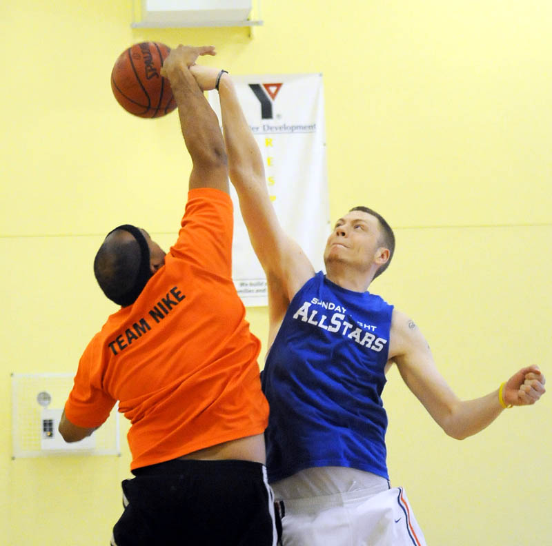 A BATTLE: Travis Dorsey of the Sunday Night All Stars, right, knocks the ball away from Jason Bray of Crew during a Kennebec Valley YMCA men’s league basketball match up Wednesday in Augusta. Dorsey is a Lawrence High School and Thomas College alum.