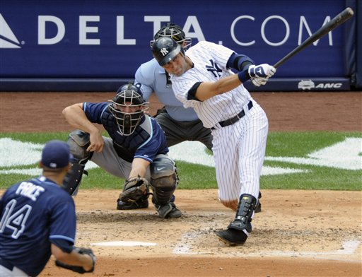 New York Yankees' shortstop Derek Jeter hit a solo home run for his 3,000 career hit during in third inning Saturday against the Tampa Bay Rays at Yankee Stadium in New York. Rays catcher John Jaso, pitcher David Price, left, and umpire Jim Wolf look on.