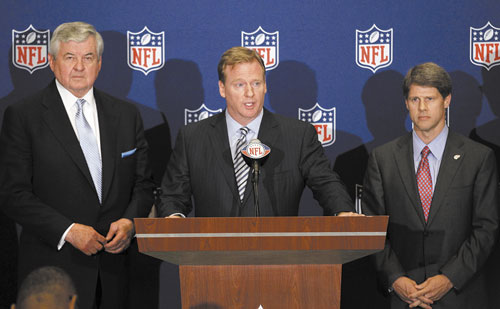 IT’S GOOD FOR US: NFL commissioner Roger Goodell, center, announces that NFL owners have agreed to a tentative agreement that would end the lockout pending the players’ approval Thursday in College Park, Ga. Carolina Panthers owner Jerry Richardson, left, and Kansas City Chiefs owner Clark Hunt look on.