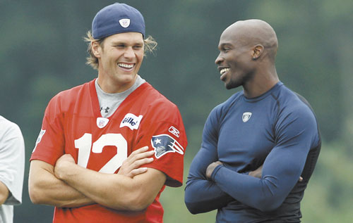 WELCOME: Tom Brady, left, and Chad Ochocinco share a laugh during a training camp session Friday at Gillette Stadium in Foxborough, Mass. Ochocinco was traded to the Patriots on Thursday from the Cincinnati Bengals, according to a source, but the deal has yet to be announced and Ochocinco cannot yet practice.
