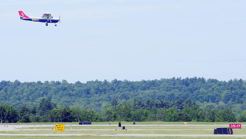 A Civil Air Patrol cadet takes a low pass over the Augusta State Airport on Tuesday morning.