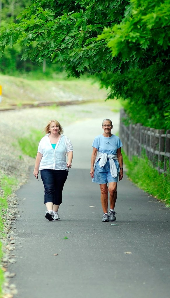 Kimberly King, left, and Jill Howes walk along the Kennebec River Rail Trail on Tuesday in Augusta. The women are is participating in the Susan G. Komen 3-Day for the Cure, which starts Sept. 23 in Washington, D.C.