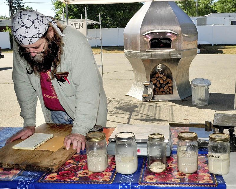 Dusty Dowse goes over notes while preparing his talk and demonstration on baking sourdough breads in a wood-fire oven during the Kneading Conference in Skowhegan on Thursday.