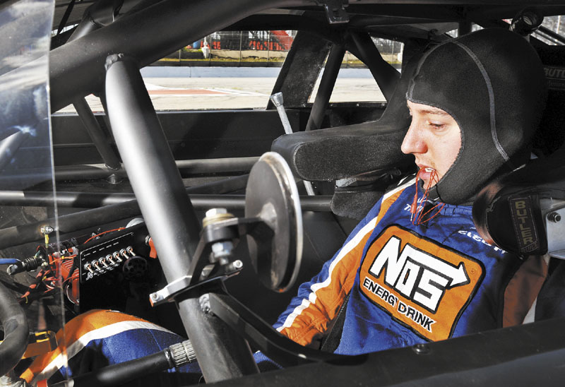 CHECKING THINGS OUT: NASCAR driver Kyle Busch settles into his car at the Oxford Plains Speedway on Thursday during testing for the upcoming TDBank 250 at the Oxford Plains Speedway.