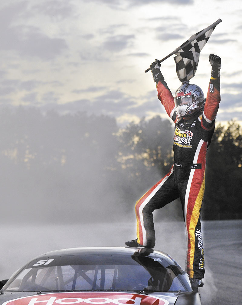 VICTORY IS MINE: Kyle Busch celebrates after winning the TD Bank 250 on Sunday at Oxford Plains Speedway.