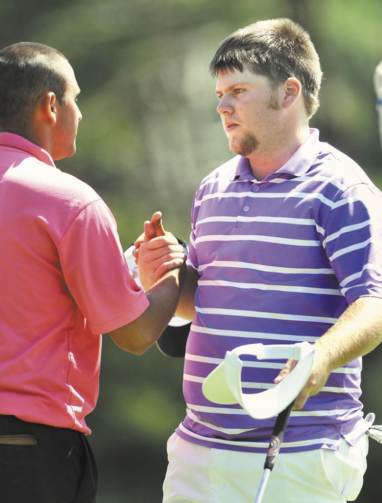 GOOD JOB, BUDDY: Ryan Gay shakes hands with Jason Harris after winning the Maine Amateur Championship for the second year in a row, Thursday at the Portland County Club in Falmouth. Gay also won the tournament in 2008. Thursday, she shot 1-over par 71 to finish at 209, one shot ahead of Harris.