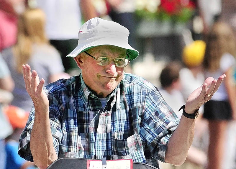 Old Hallowell Day Citizen of the Year Dick Bachelder gestures at someone in the crowd while riding in the parade down Water Street on Saturday morning.