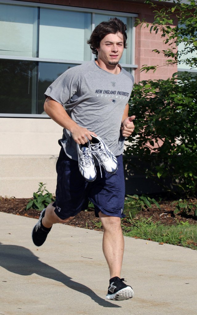 HURRY UP: New England Patriots’ running back Danny Woodhead runs out of Gillette Stadium in Foxborough, Mass. on Wednesday as the Patriots prepared for their first day of training camp, which kicks off today.
