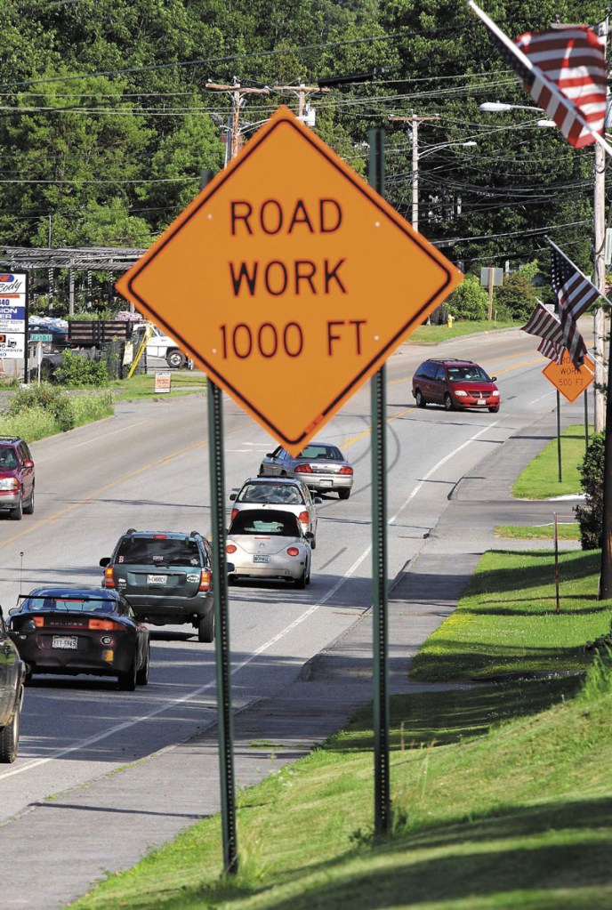 WORK AREA: Motorists pass near a construction zone located on Routes 201 and 27 in Farmingdale on Saturday evening. The state has scaled back on road work due to budget constraints.