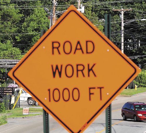 Motorists pass near a construction zone located on Routes 201 and 27 in Farmingdale Saturday evening. The state has scaled back on road work due to budget constraints.