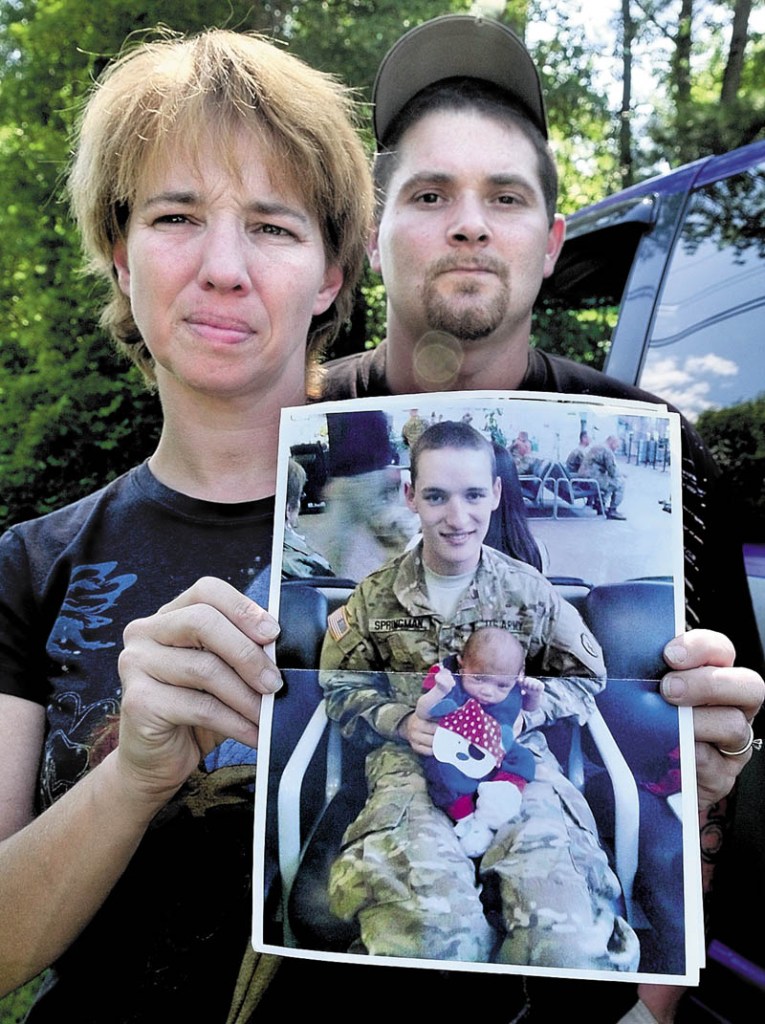 SOLDIER’S MOTHER: Tina Stratton of Hartland holds a recent photo of her son, Tyler Springmann, on Tuesday. At right is Stratton’s husband, Ben Martin.