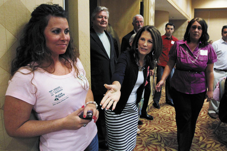 CONTENDER: Presidential candidate U.S. Rep. Michele Bachmann, R-Minn., center, arrives at a breakfast before the Iowa Republican Party's straw poll Saturday in Ames, Iowa. Rep. Bachmann was victorious in the poll.