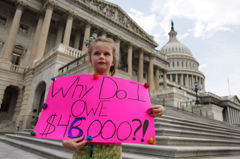 LITTLE VOICE: Holly Matthews, 7, of Kansas City, Mo., holds a sign supporting a balanced budget amendment just before the House would vote to pass debt legislation on Capitol Hill in Washington on Monday.