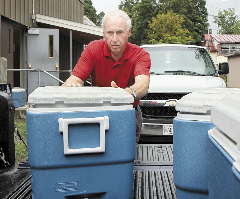 A VOLUNTEER EFFORT: Gilman Pelletier loads 300 dinners into his truck to take to Skowhegan while volunteering for Meals of Wheels on Thursday morning. Pelletier was recently given the 2011 Spirit of America Volunteer Award at a Waterville City Council meeting for his volunteer work.