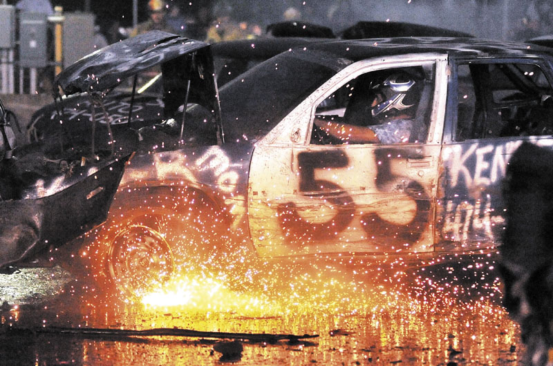 REVVED UP: Bill Towers, in the No. 55 car, shoots sparks at the Skowhegan State Fair's demolition derby on Friday.