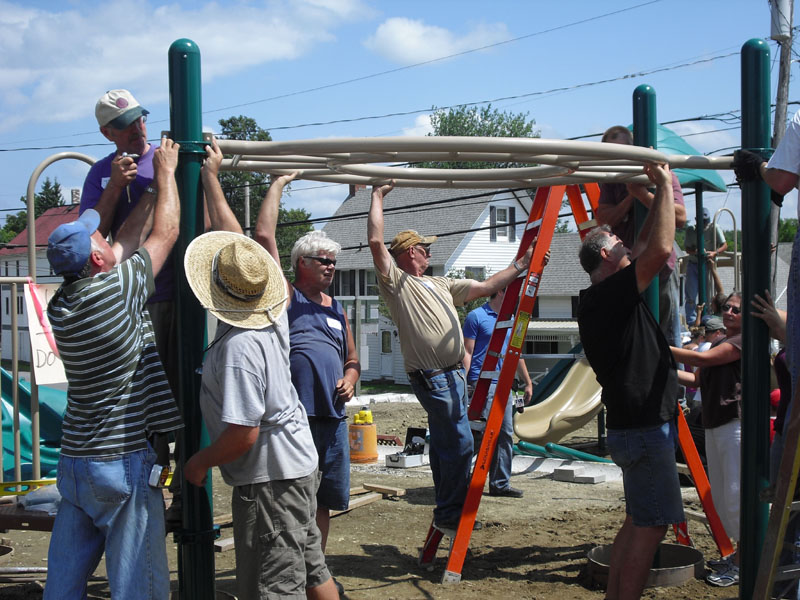 BUILDING: Community volunteers assemble a new community playground in St. Albans recently.