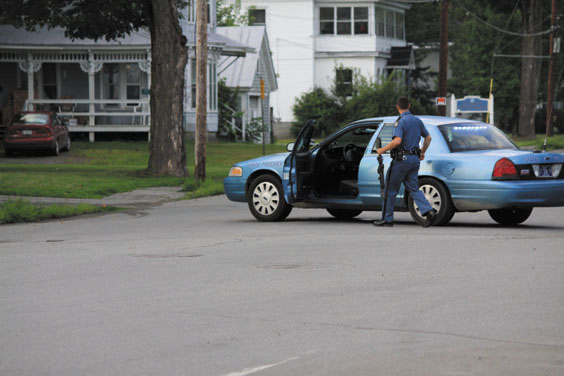 AT THE SCENE: An officer with the Maine State Police responds Saturday evening to a standoff on Weston Avenue in Madison. The man who refused to leave his home, Rodney Thibodeau, 53, was eventually arrested on a charge of domestic violence assault after his mother pursuaded him to come outside.