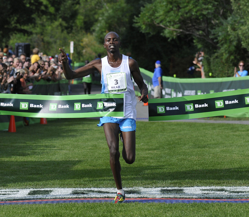 Micah Kogo of Kenya is the first to cross the finish line at the 2011 TD Bank Beach to Beacon 10K on Saturday in Cape Elizabeth.