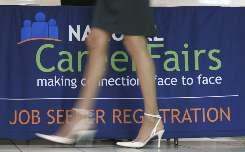 A job seeker enters a career job fair in Arlington, Va. on Thursday. The Labor Department announced today that hiring picked up slightly in July and the unemployment rate dipped to 9.1 percent as employers added 117,000 jobs.