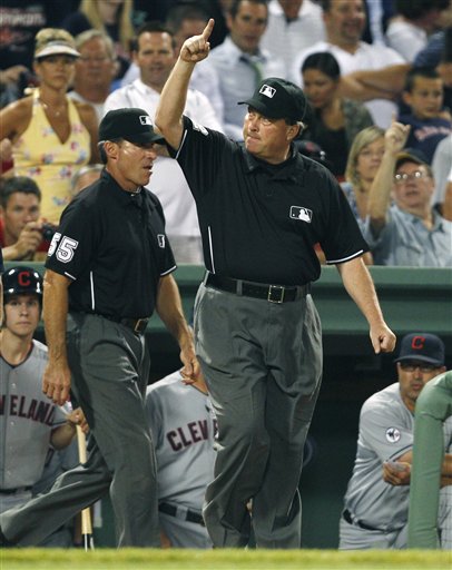 Umpire crew chief Gerry Davis signals a home run by Cleveland Indians' Asdurbal Cabrera after watching video replays, during the eighth inning of the Indians' 9-6 win over the Boston Red Sox on Monday at Fenway Park in Boston.