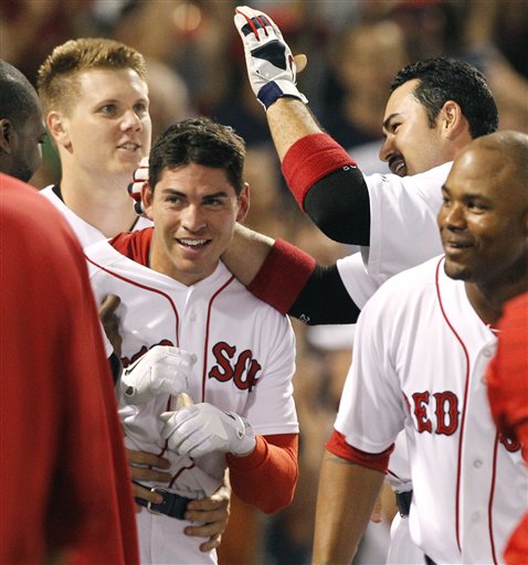 Boston's Jacoby Ellsbury, second from left, is congratulated by teammates, from left, Jonathan Papelbon, Adrian Gonzalez and Carl Crawford after he hit a walk-off home run in the ninth inning to defeat the Cleveland Indians 4-3 Wednesday night at Fenway Park in Boston.