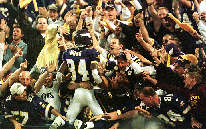 In this Oct. 9, 2000, photo Minnesota Vikings wide receiver Randy Moss (84) jumps into the crowd to celebrate his 42-yard touchdown pass from Daunte Culpepper against the Tampa Bay Buccaneers.