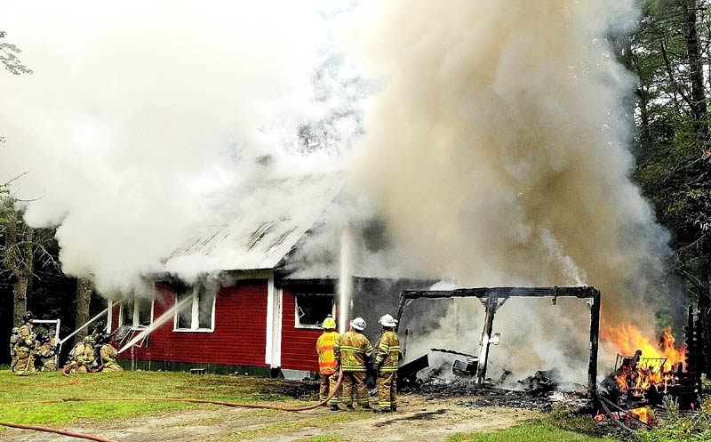 Firefighters from several area towns battle a house fire on Wings Mills Road on this afternoon in Mount Vernon.