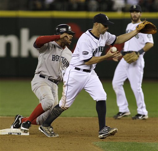 Boston Red Sox' Darnell McDonald, left, protests after he was forced at second by Seattle Mariners' Jack Wilson, center, in the eighth inning of a baseball game, Saturday, Aug. 13, 2011, in Seattle. (AP Photo/Ted S. Warren)