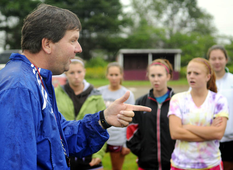 THE POINT: Richmond High School girls soccer coach Troy Kendrick address his players Monday during the defending Class D champions first day of practice. Athletes at schools across Maine took to soggy fields for the commencement of the 2011-2012 high school sports season.