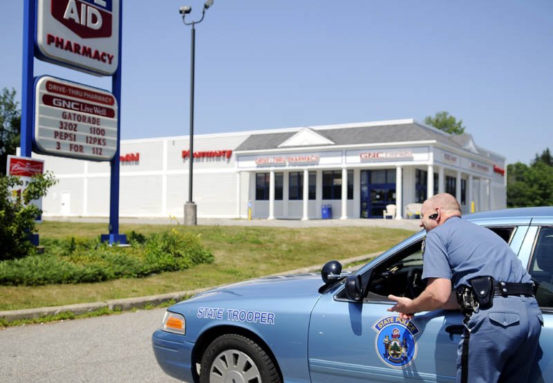 Maine State Police Lt. Donald R. Pomelow, right, speaks to trooper Jeff Beach Monday outside the Manchester Rite Aid following a robbery at the store that occurred at approximately 11 a.m.
