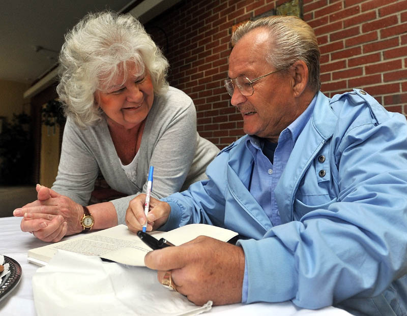 FOR YOU: Ron Turcotte signs an autograph for Carole Hemingway before speaking at Spectrum Generations at the Muskie Center on Tuesday in Waterville. Turcotte is a Hall of Fame jockey and is most famously known for riding Secretariat to the Triple Crown in 1973.