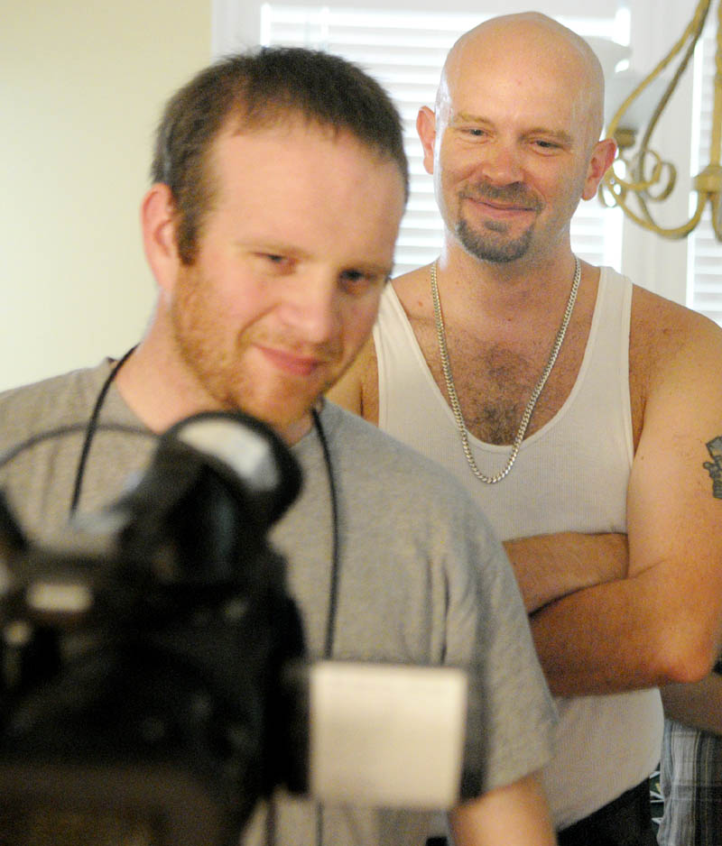 Jon Markham, left, and Chris Walters watch the playback of a scene Markham just shot while they were filming "SRQ State of Mind" last week inside a house in Hallowell. The feature film, written, produced and starring Chris Walters, has been filmed at various locations in the area.