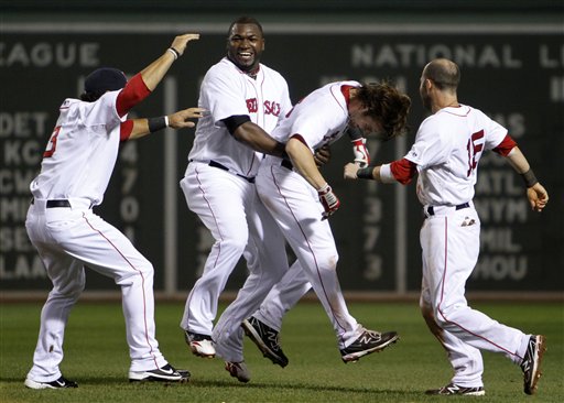 Boston Red Sox's David Ortiz, second from left, lifts Josh Reddick, second from right, as Mike Aviles, left, and Dustin Pedroia, right, come in to celebrate after Reddick's RBI single gave the Red Sox the walk-off, 3-2 win against the New York Yankees in the 10th inning of Sunday in Boston.
