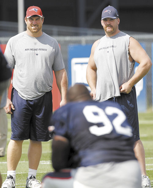 BACK FOR MORE: Signed but unable to practice yet, New England Patriots offensive lineman Matt Light, left, and Logan Mankins check out new teammate Albert Haynesworth (92) during training camp Tuesday in Foxborough, Mass.