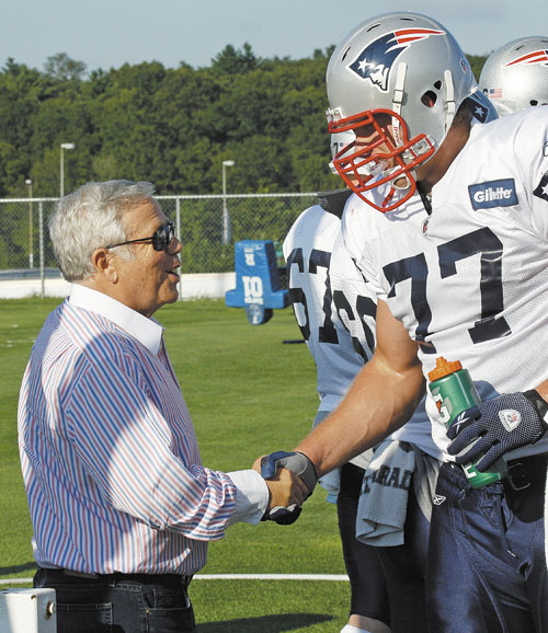 GLAD TO BE HERE: New England Patriots owner Robert Kraft, left, shakes hands with tackle Nate Solder during training camp Thursday in Foxborough, Mass. Solder ended his brief holdout and joined the team for practice Thursday.