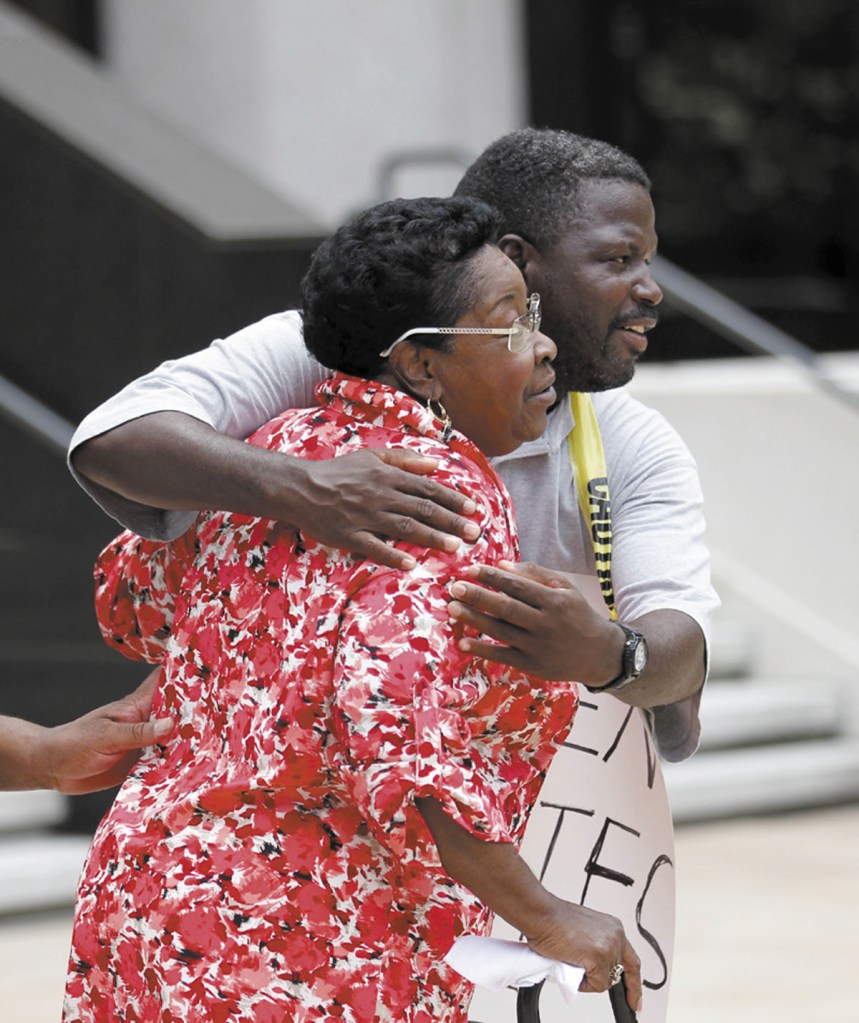 Rebecca Glover, aunt of a victim of a separate civil rights case against New Orleans police officers, hugs supporters of victims and their families outside Federal Court after five current or former police officers were convicted in the deadly shootings on a New Orleans bridge after Hurricane Katrina, in New Orleans on Friday. Former officer Robert Faulcon, Sgts. Robert Gisevius and Kenneth Bowen, Officer Anthony Villavaso and retired Sgt. Arthur Kaufman were convicted of charges stemming from the cover-up of the shootings. All but Kaufman were convicted of civil rights violations stemming from the shootings. Kaufman, who investigated the shootings, was charged only in the cover-up.