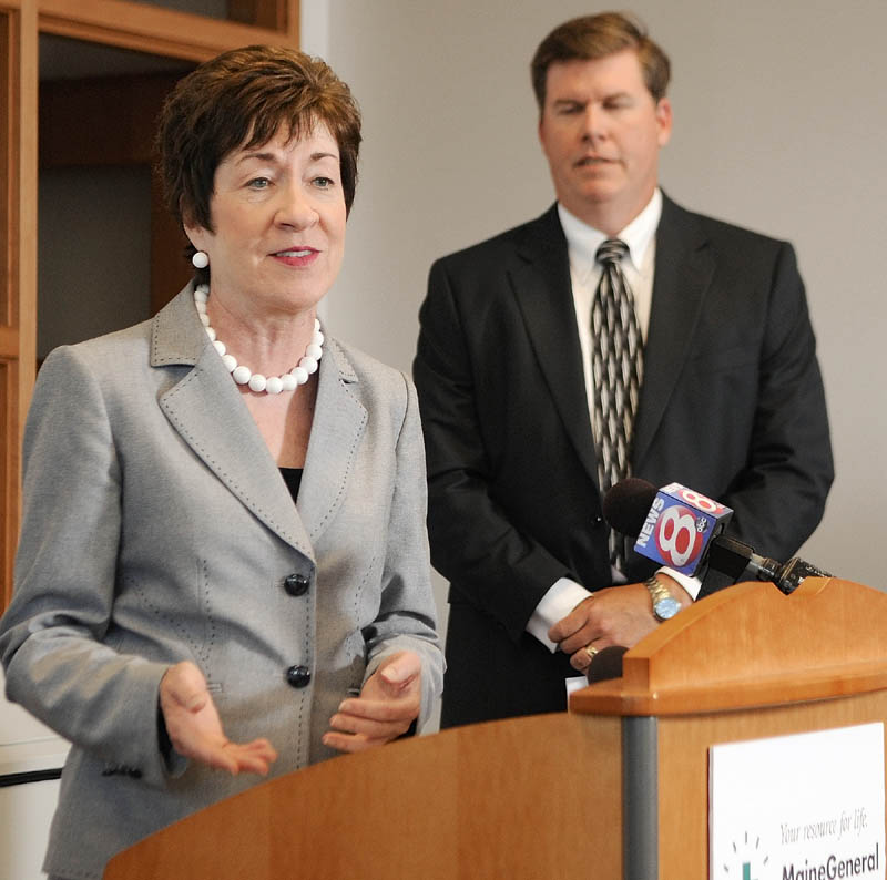 Maine General Medical Center Chief Executive Officer Chuck Hays, right, listens as U.S. Sen. Susan Collins, R-Maine, announces funding for exit 113 on Friday at the Harold Alfond Center for Cancer Care, one of the major facilities that motorists will find easier to access via the new ramps.