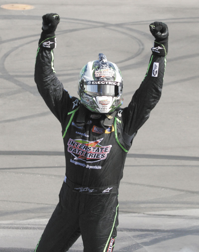 MASKED MAN: Kyle Busch celebrates his victory in the NASCAR Sprint Cup Series race Sunday at Michigan International Speedway in Brooklyn, Mich.