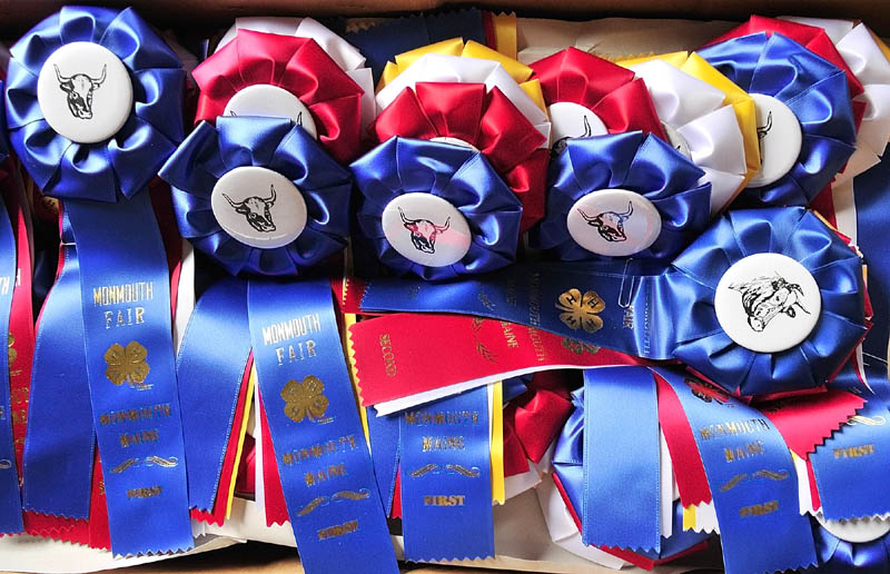 A box of ribbons with cattle buttons await winners of the 4-H and open beef and dairy cattle shows on Thursday morning at the Monmouth Fairgrounds on Academy Road in Monmouth. The fair runs through Saturday.