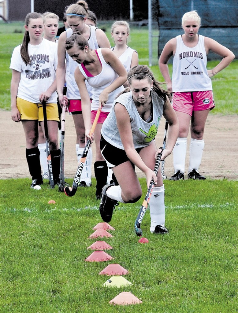 Nokomis Regional High School field hockey player Marissa Shaw, front, practices with other players on Monday.