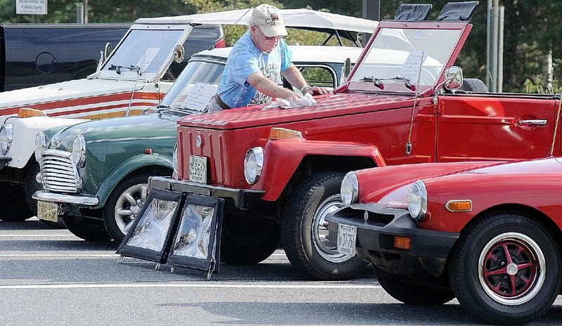 Edwin Howe, of Bryant Pond, polishes his 1974 Volkswagon Thing for the 2nd annual Ricky Gibson car show at the Maranacook Community School on Saturday morning during Readfield Heritage Days.